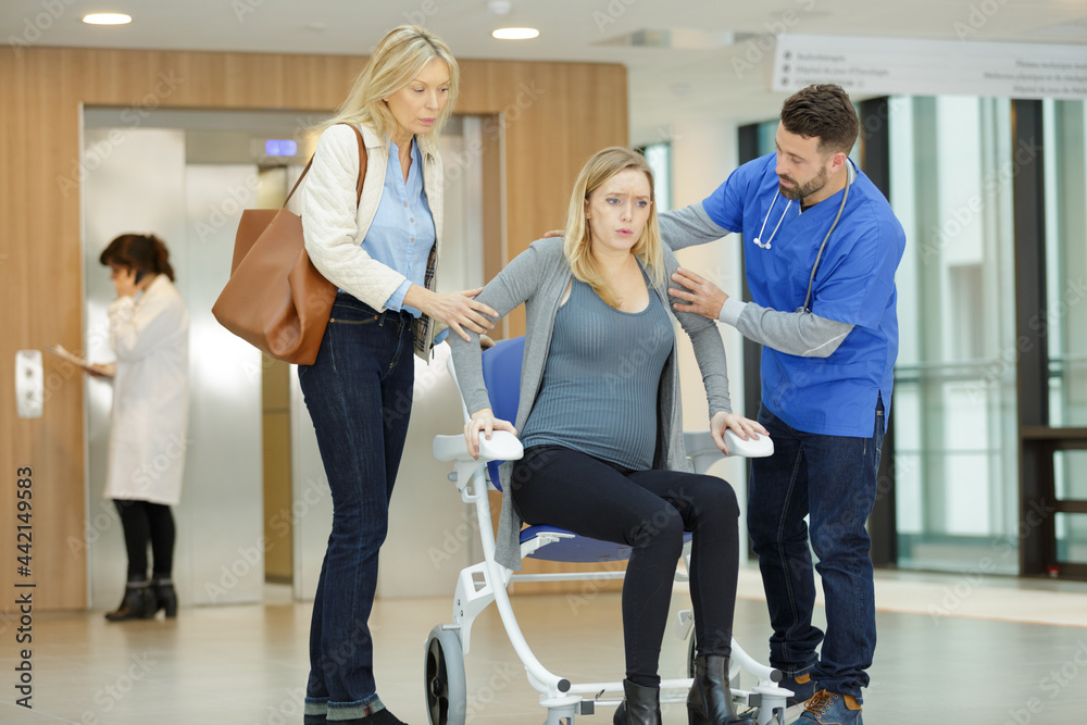 young pregnant woman in hospital lobby young pregnant woman in hospital lobby