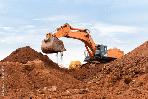 large excavator loads rock with iron or bauxite mining