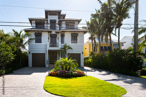 Bonita Springs, Florida gulf of mexico coast with luxury villa mansion house buildings waterfront architecture colorful painted and garage © Andriy Blokhin