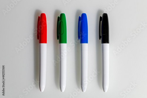 Four multicolored markers on a white background