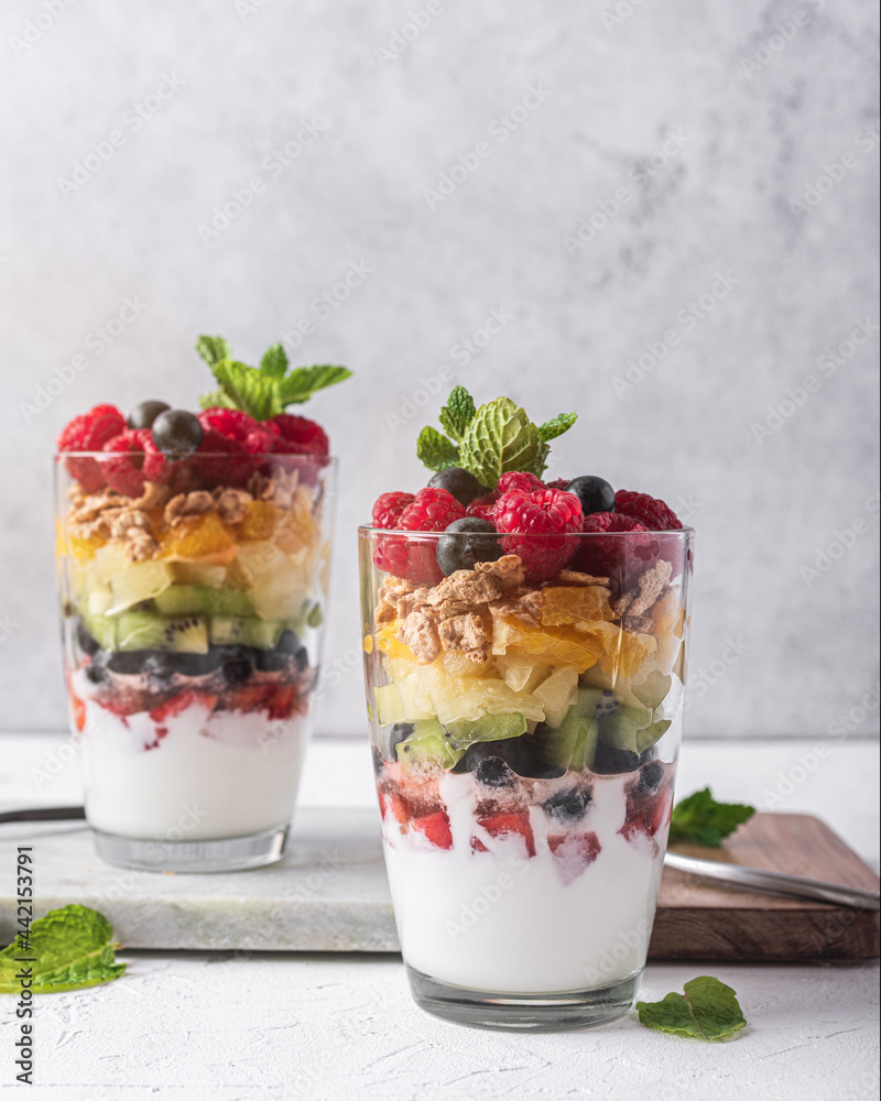 Delicious yogurt with assorted fruits in glasses Delicious yogurt with assorted fruits in glasses