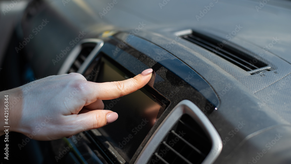 Wipe dust off car dashboard with finger.