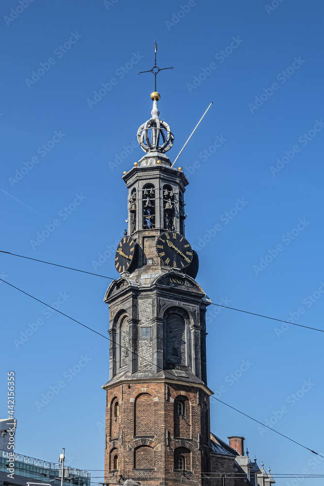 Fragment of Amsterdam Mint Tower (or Munttoren, 1620) at Muntplein square near flower market. Munttoren was originally part of gate in Amsterdam's medieval city wall. Amsterdam, the Netherlands. Fragment of Amsterdam Mint Tower (or Munttoren, 1620) at Muntplein square near flower market. Munttoren was originally part of gate in Amsterdam's medieval city wall. Amsterdam, the Netherlands.