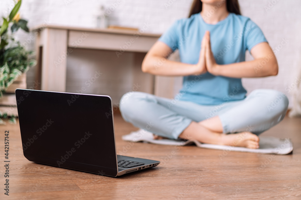 Young girl watching training yoga meditation video online