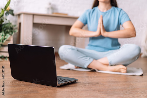 Young girl watching training yoga meditation video online