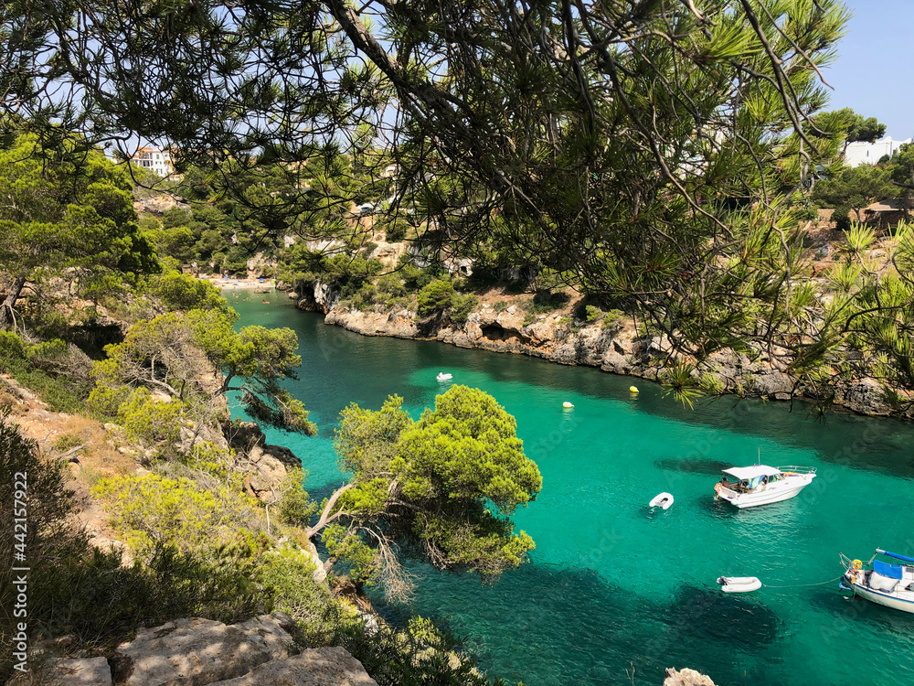 Cala Pi bay in the southern part of Mallorca with crystal clear turquoise water and yachts