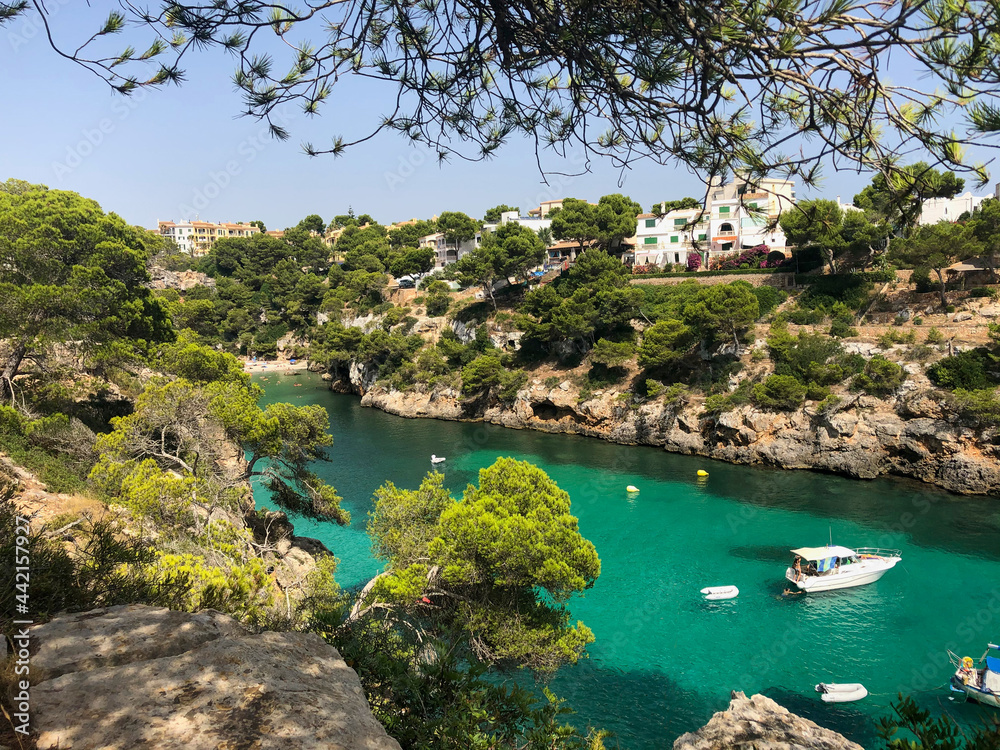 Cala Pi bay in the southern part of Mallorca with crystal clear turquoise water and yachts from above