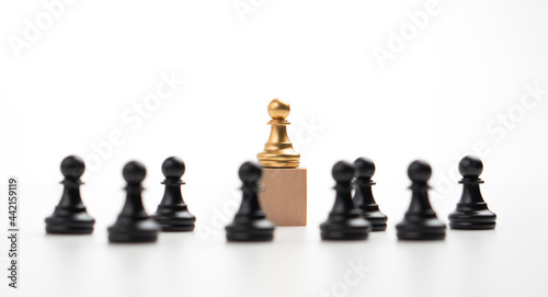 The leadership of the Golden chess pawn standing on the box show influence and empowerment. Concept of business leadership for leader team, successful competition winner and Leader with strategy