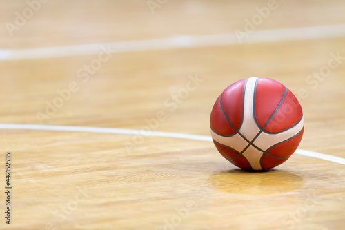 Basketball on hardwood court floor. Professional sport concept