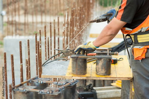 Welder-builder welds a metal structure, close-up