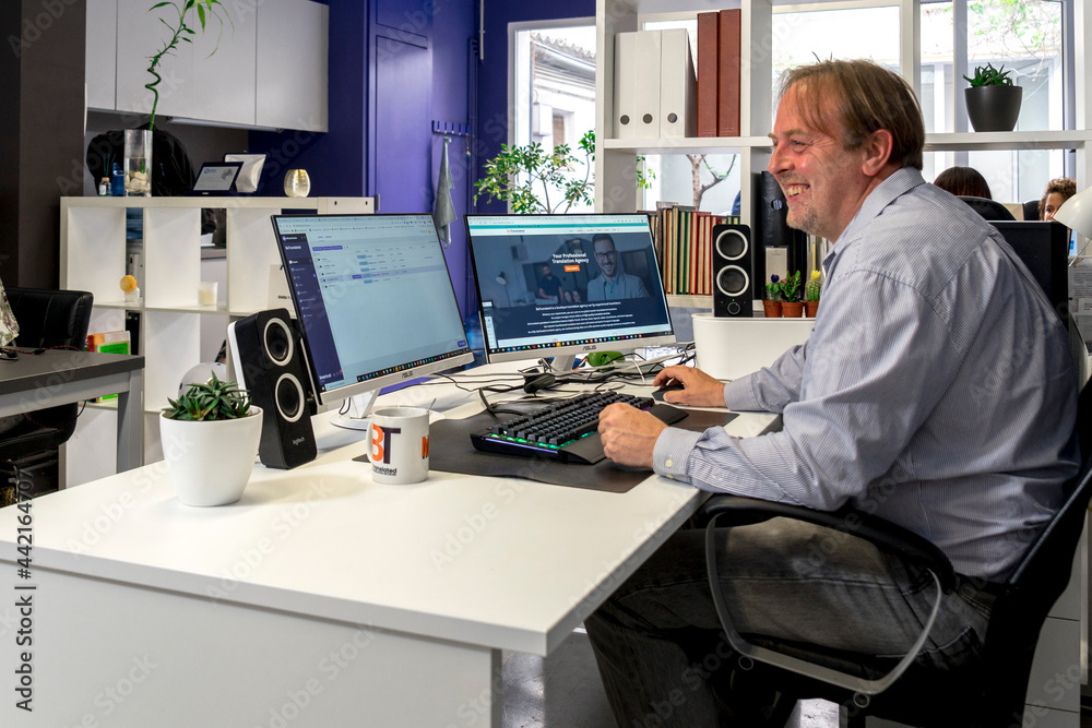 Man sitting in front of the PC in his office Man sitting in front of the PC in his office