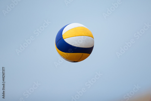 Volleyball game. Beach volleyball ball in the sky.