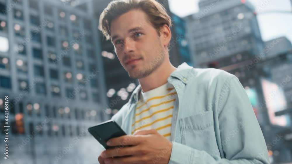 Portrait of a Handsome Young Man Wearing Casual Clothes and Using Smartphone on the Urban Street. Stylish Male in Big City Connecting with People Online, Messaging and Browsing Internet. Portrait of a Handsome Young Man Wearing Casual Clothes and Using Smartphone on the Urban Street. Stylish Male in Big City Connecting with People Online, Messaging and Browsing Internet.