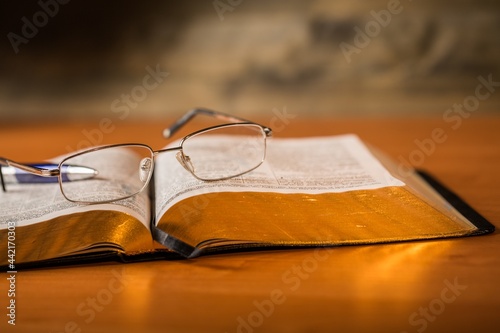 Open Bible with Pen and Eyeglasses
