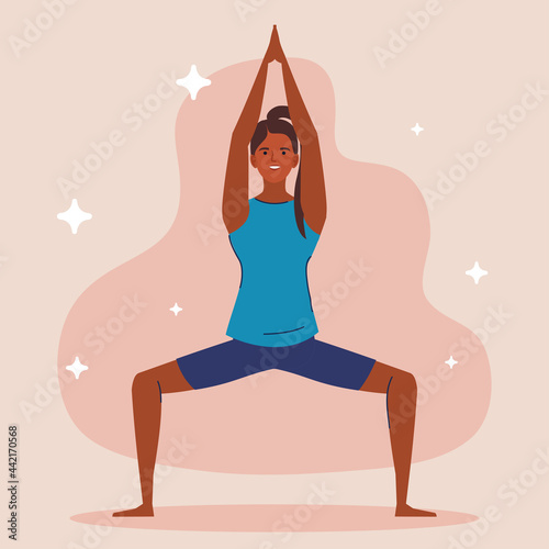 young woman afro practicing yoga
