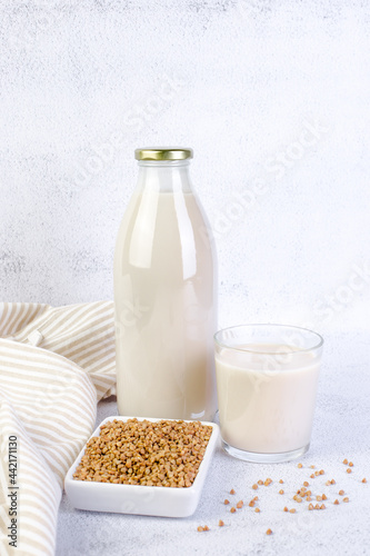 Buckwheat milk in glass bottle and glass.
