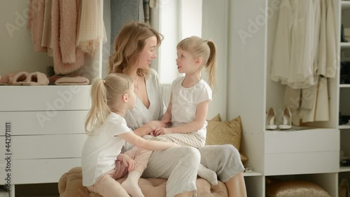 mom sits with her twins and laughs