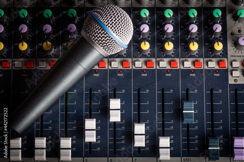 Microphone in front of a sound board photo