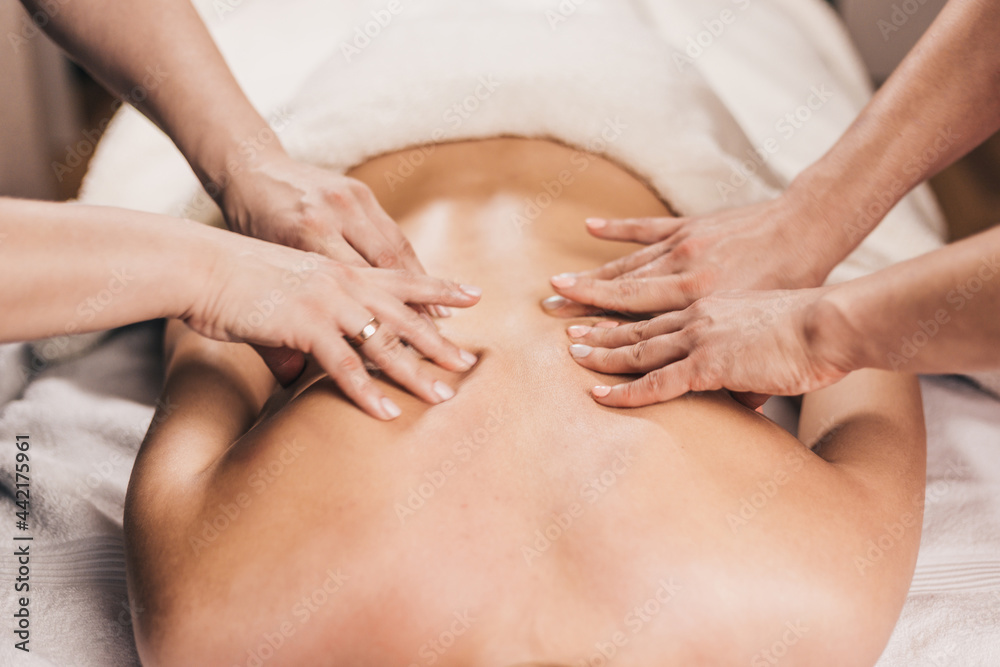 Deep lumbar back massage - woman on massage table Deep lumbar back massage - woman on massage table