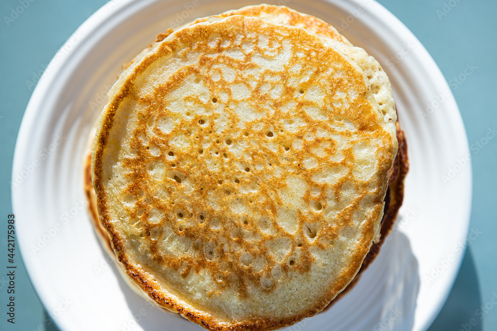 Macro closeup flat top view of stack of buttermilk pancakes on plate as traditional breakfast brunch dessert Macro closeup flat top view of stack of buttermilk pancakes on plate as traditional breakfast brunch dessert