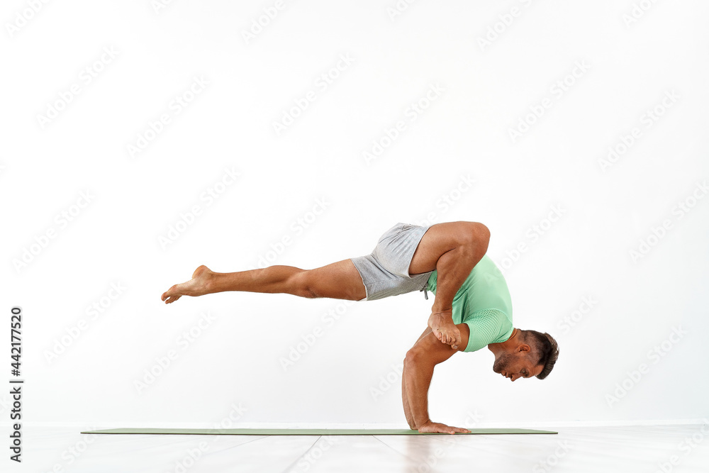 Man practicing balance yoga pose Man practicing balance yoga pose