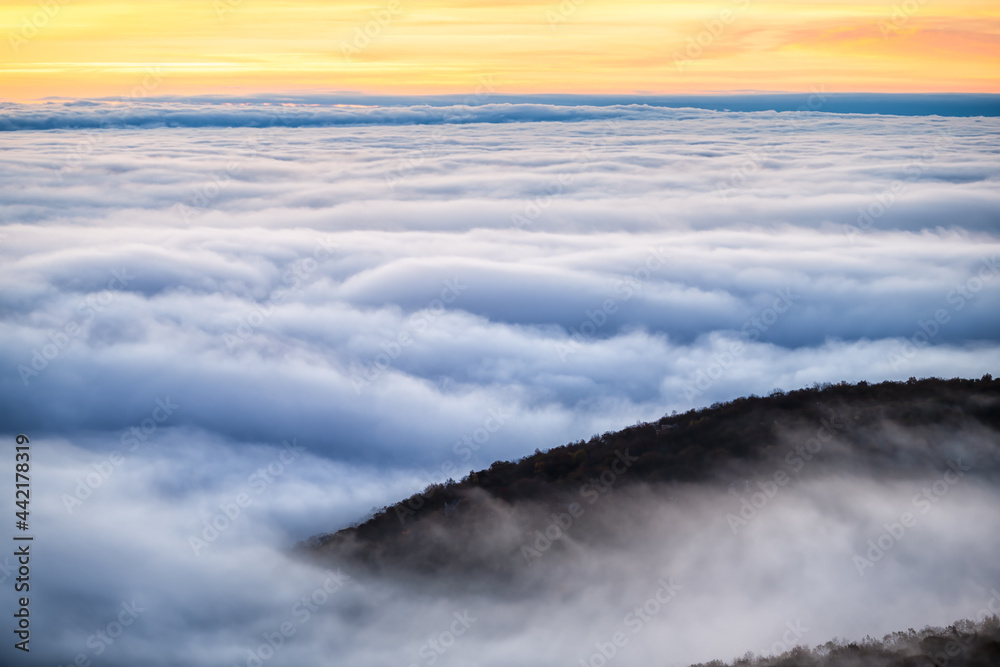 Clouds mist fog covering mountain peak in Wintergreen resort town in Blue Ridge mountains in autumn fall high angle aerial above view of inversion cloud