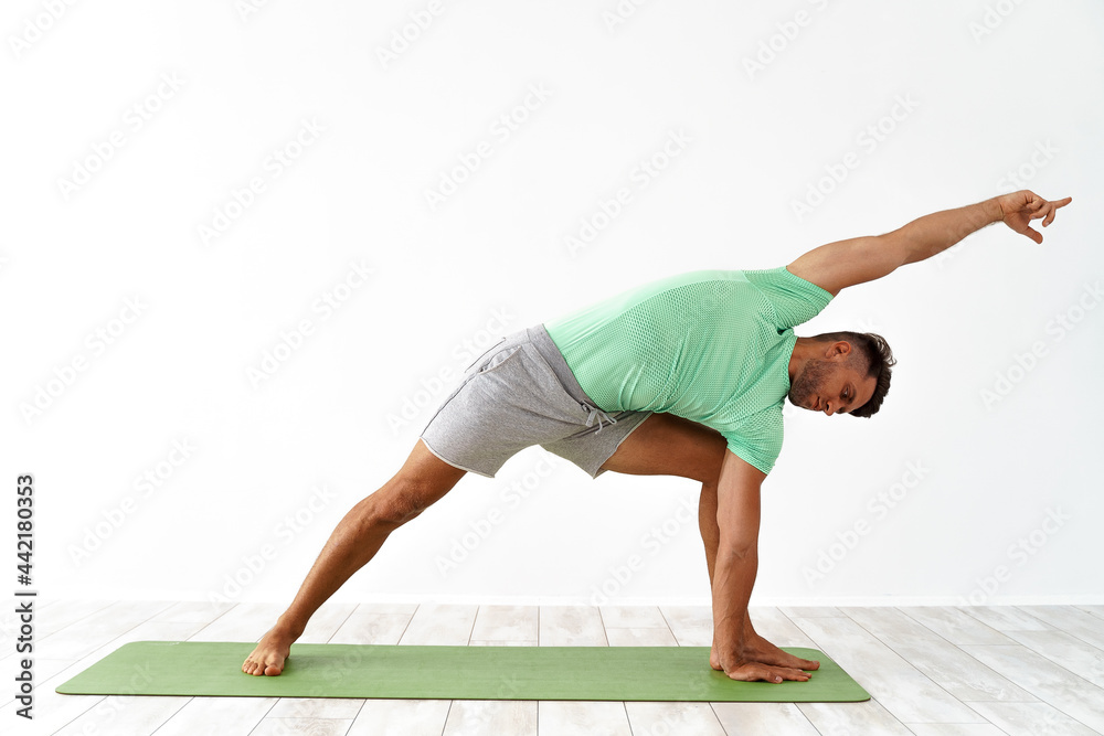 Young handsome man doing yoga isolated on white background