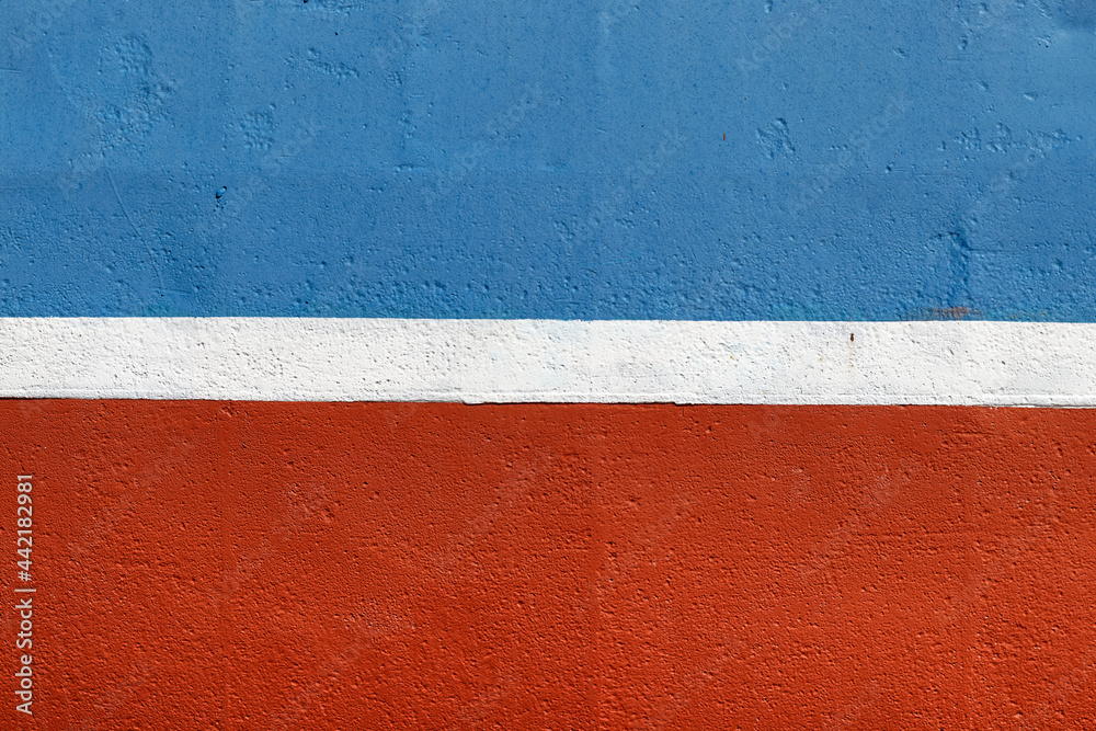 Fototapeta premium Blue-red side of the ship with a white stripe