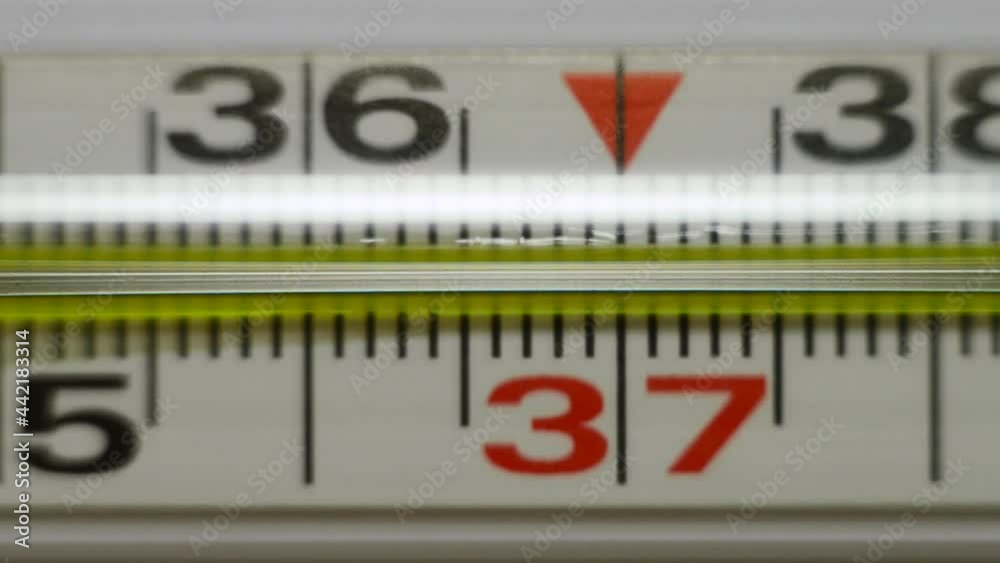 A mercury thermometer shows an increase in body temperature. Measurement of body temperature in case of illness. A mercury thermometer shows an increase in body temperature. Measurement of body temperature in case of illness.