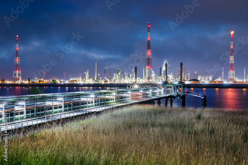 View on large petrochemical production plant on riverbank at twilight  Port of Antwerp