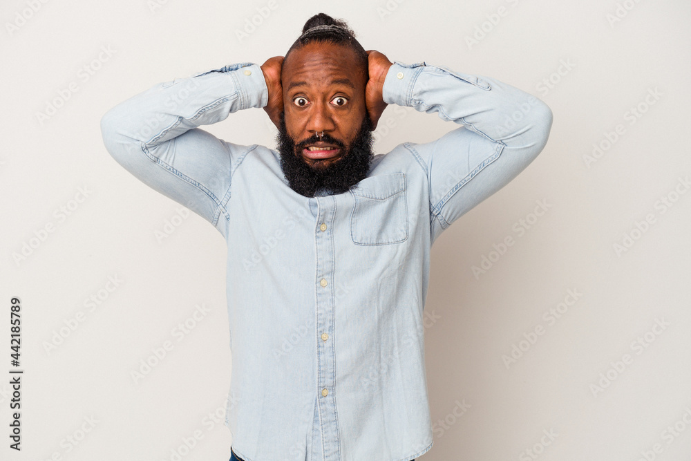 African american man with beard isolated on pink background screaming with rage. African american man with beard isolated on pink background screaming with rage.