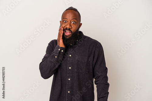African american man with beard isolated on pink background shouts loud, keeps eyes opened and hands tense.