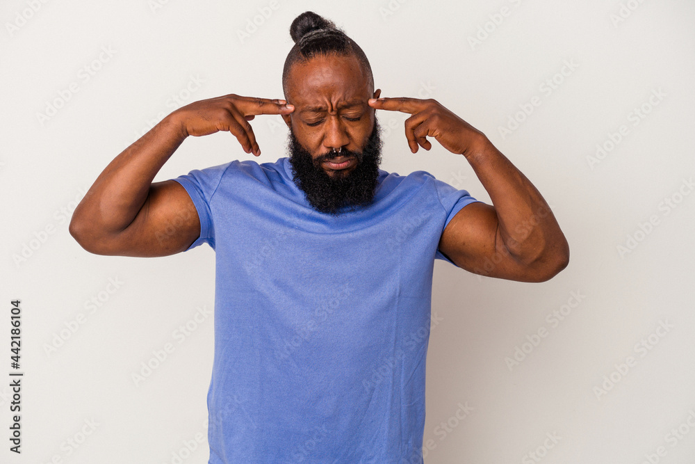 African american man with beard isolated on pink background focused on a task, keeping forefingers pointing head. African american man with beard isolated on pink background focused on a task, keeping forefingers pointing head.