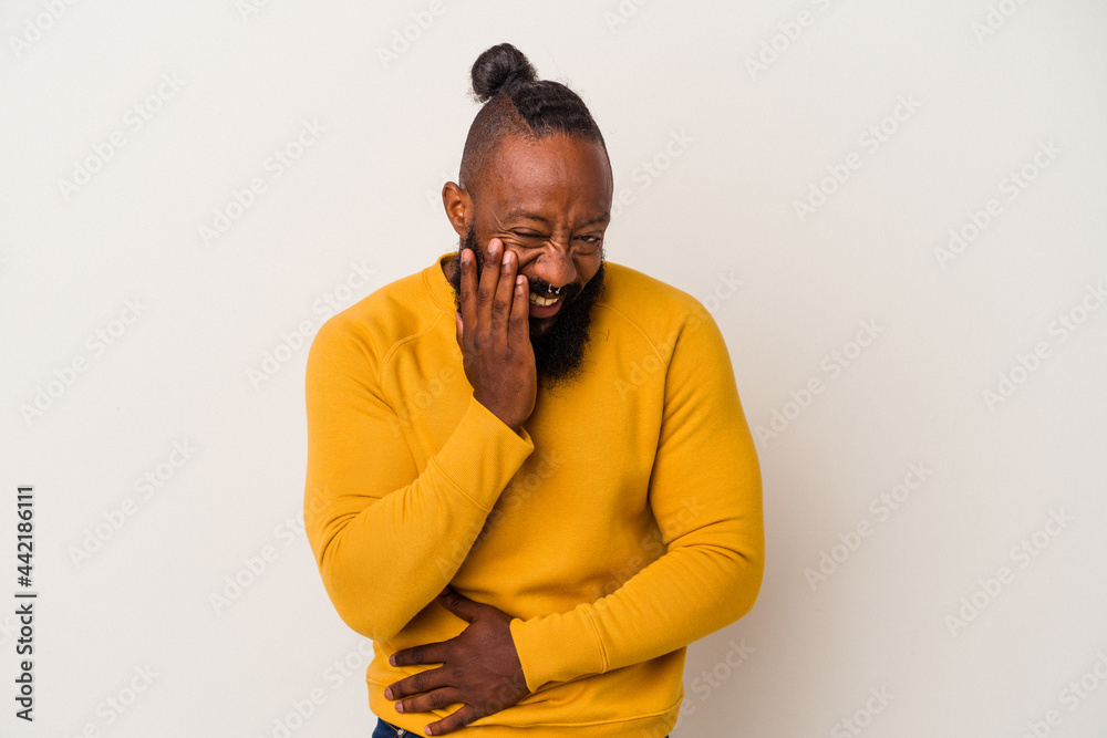 African american man with beard isolated on pink background laughs happily and has fun keeping hands on stomach. African american man with beard isolated on pink background laughs happily and has fun keeping hands on stomach.