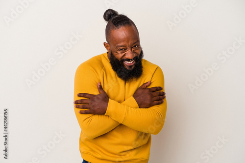 African american man with beard isolated on pink background laughing and having fun.