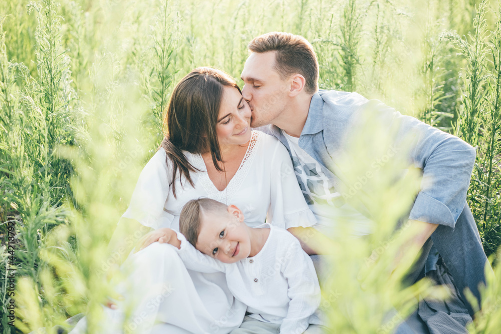 Happy family resting in the field. Happy family resting in the field.