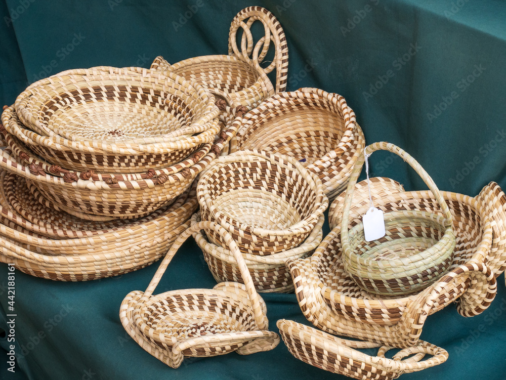 Fototapeta premium pile of handcrafted sweet grass baskets for sale