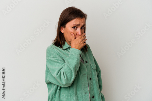 Middle age caucasian woman isolated on white background covering mouth with hands looking worried.