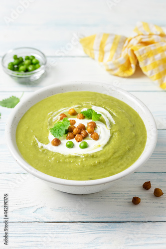Green pea split soup on wooden background. Copy space.