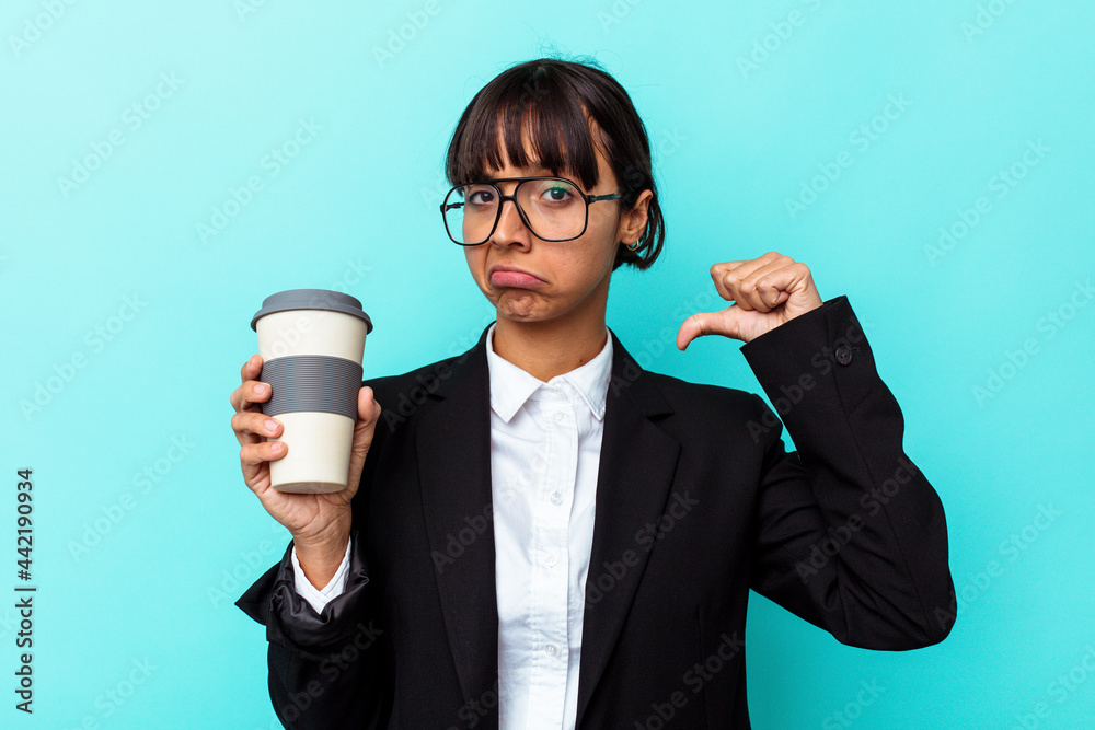 Young business mixed race woman holding a coffee isolated on blue background feels proud and self confident, example to follow. Young business mixed race woman holding a coffee isolated on blue background feels proud and self confident, example to follow.