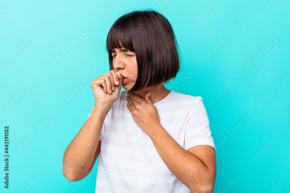 Young mixed race woman isolated on blue background suffers pain in throat due a virus or infection. Young mixed race woman isolated on blue background suffers pain in throat due a virus or infection.