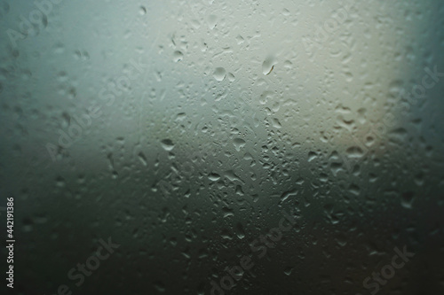 Close-up of window with raindrops background cloudy sky. Concept. Beautiful rain background with raindrops on glass. Raindrops on window run down. High quality photo