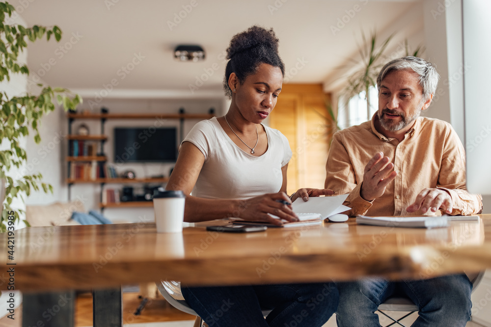 Adult black woman, writing down her talking points, with husband. Adult black woman, writing down her talking points, with husband.