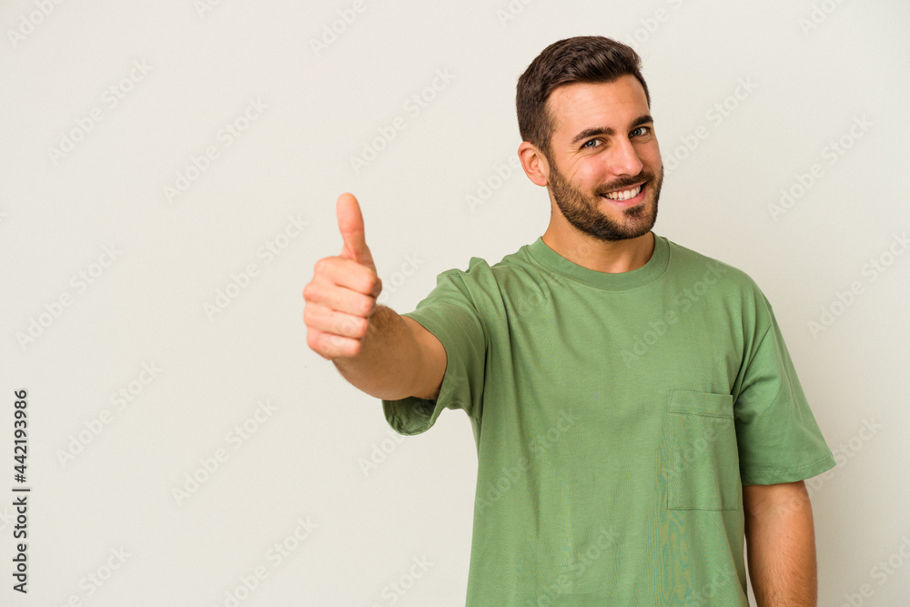 Young caucasian man isolated on white background smiling and raising thumb up Young caucasian man isolated on white background smiling and raising thumb up