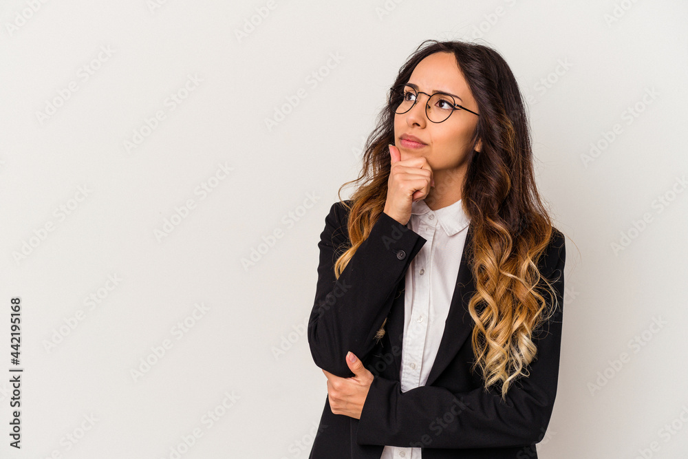 Young mexican business woman isolated on white background looking sideways with doubtful and skeptical expression. Young mexican business woman isolated on white background looking sideways with doubtful and skeptical expression.