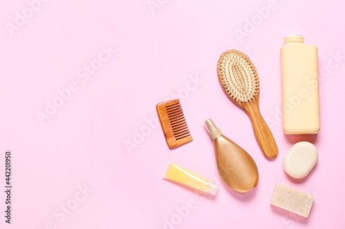 Hair brush  comb and cosmetics on color background