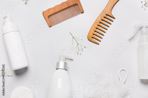 Hair combs  sponge and cosmetics on grey background