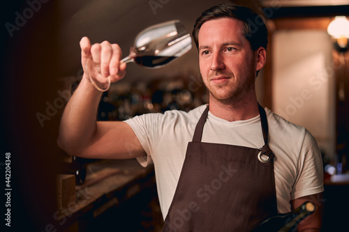 Male sommelier satisfied with the quality of wine