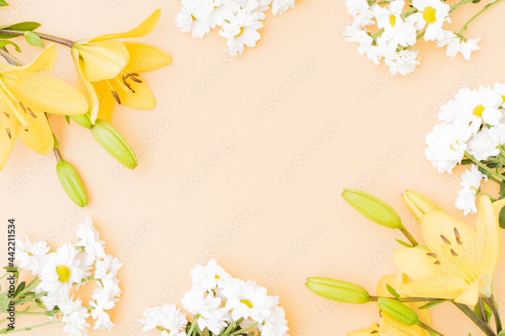 Flat lay frame with yellow lilies on color background