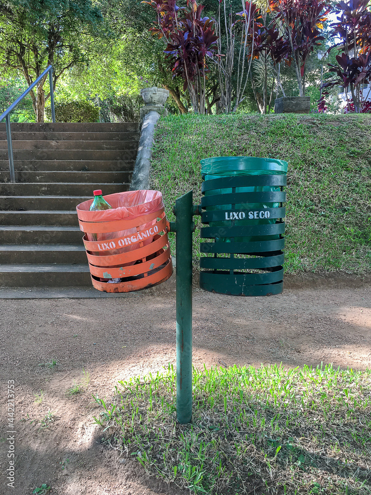 trash bins at a public park separated by organic and recyclable trash trash bins at a public park separated by organic and recyclable trash